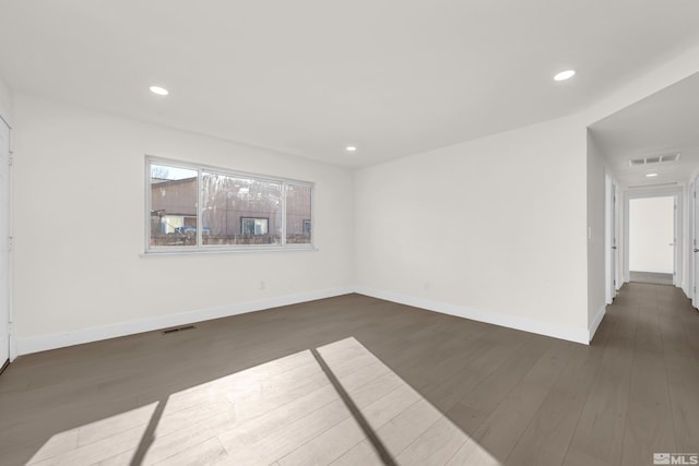 unfurnished room featuring dark wood-type flooring