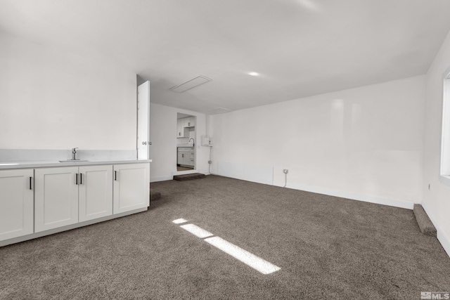 unfurnished living room with dark carpet and sink