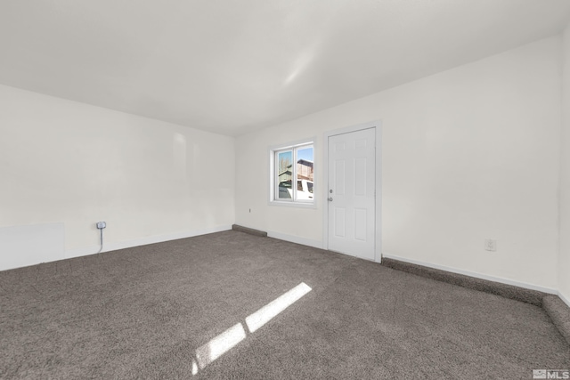 empty room with dark carpet