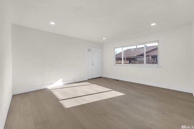 unfurnished room with light hardwood / wood-style flooring