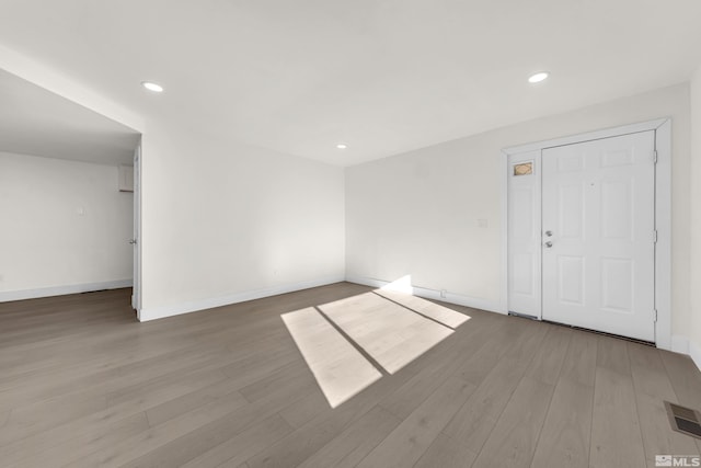 unfurnished room with hardwood / wood-style flooring