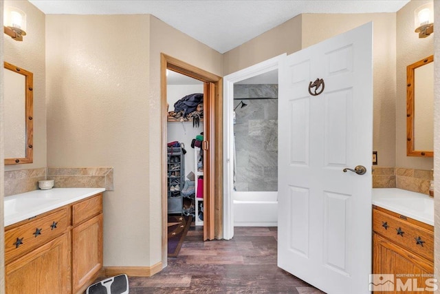 bathroom featuring hardwood / wood-style floors, vanity, and independent shower and bath