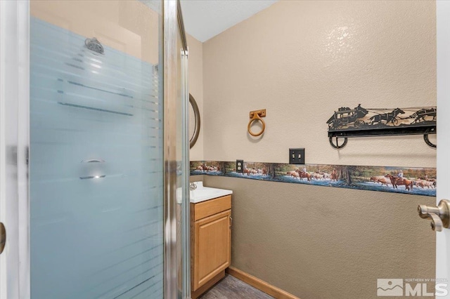 bathroom with vanity, vaulted ceiling, and walk in shower