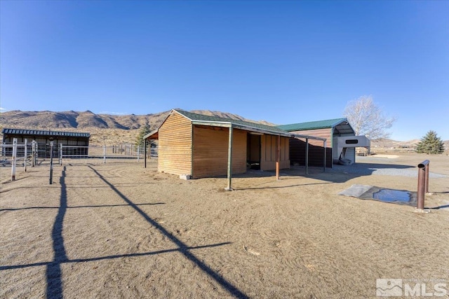 exterior space featuring a mountain view and an outdoor structure