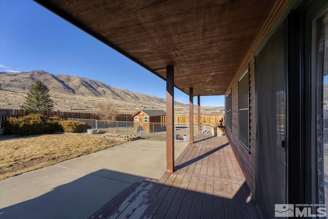 deck featuring a mountain view and a storage shed