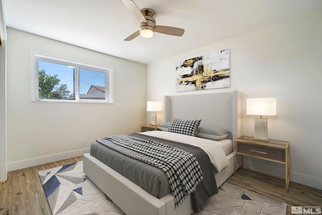 bedroom with ceiling fan and light hardwood / wood-style flooring