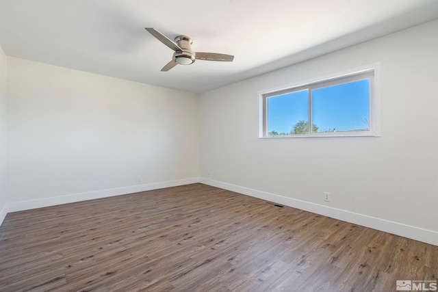 unfurnished room featuring hardwood / wood-style flooring and ceiling fan