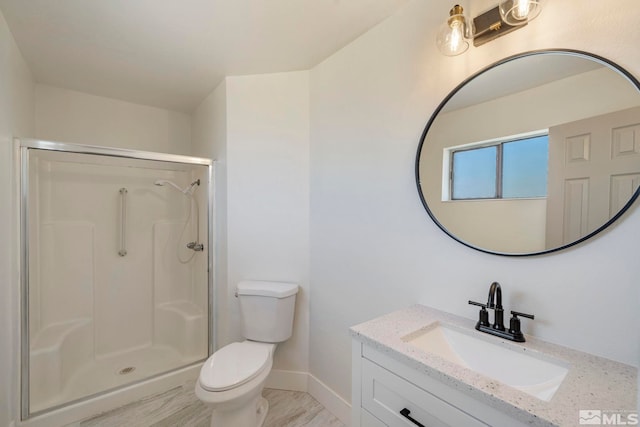 bathroom featuring a shower, hardwood / wood-style floors, vanity, and toilet