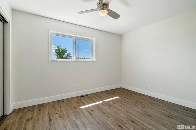 empty room with wood-type flooring and ceiling fan