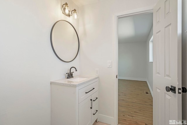 bathroom with hardwood / wood-style floors and vanity