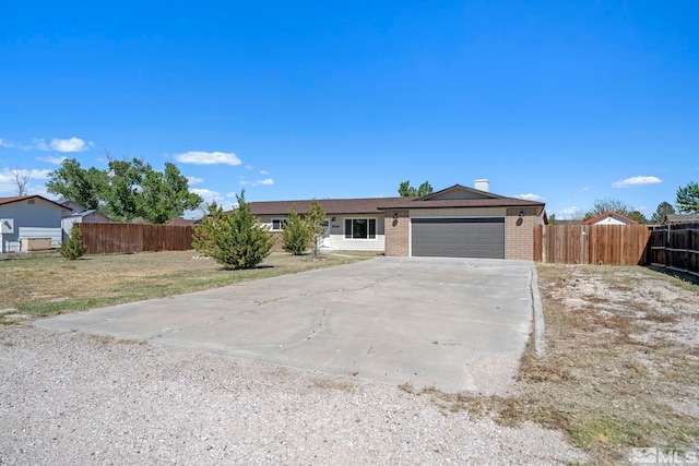 ranch-style home with a garage and a front lawn