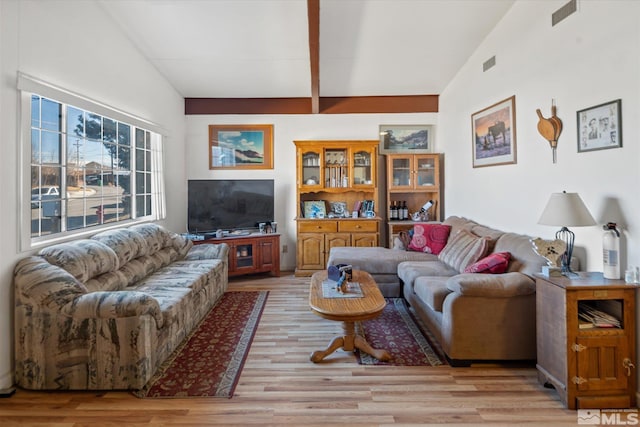 living room with light wood-type flooring and vaulted ceiling