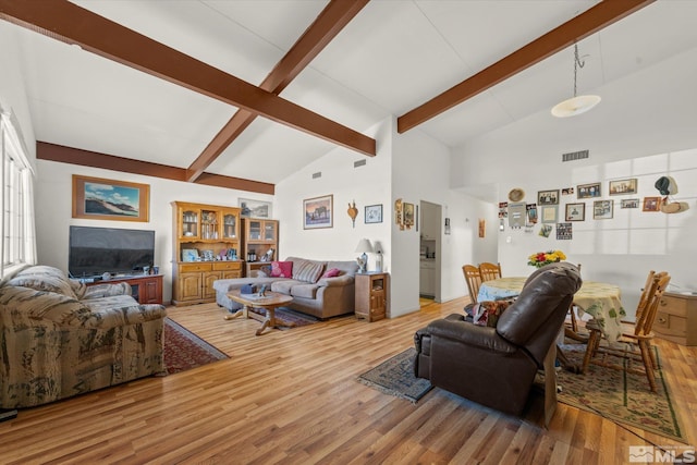 living room featuring hardwood / wood-style flooring and high vaulted ceiling