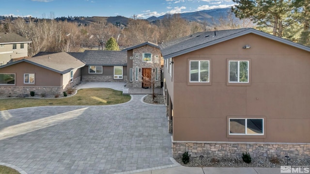 view of front facade featuring a mountain view and a patio