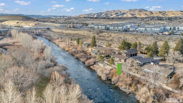 birds eye view of property with a mountain view