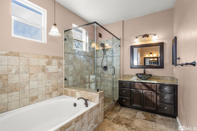 bathroom featuring vanity and independent shower and bath