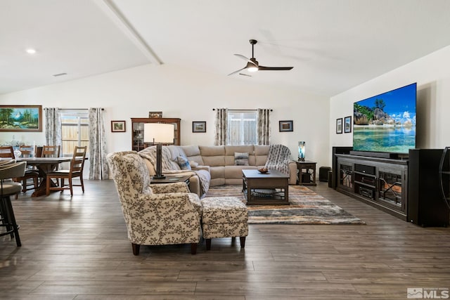 living room featuring ceiling fan, lofted ceiling, and dark wood-type flooring