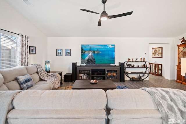 living room featuring hardwood / wood-style flooring, ceiling fan, and lofted ceiling