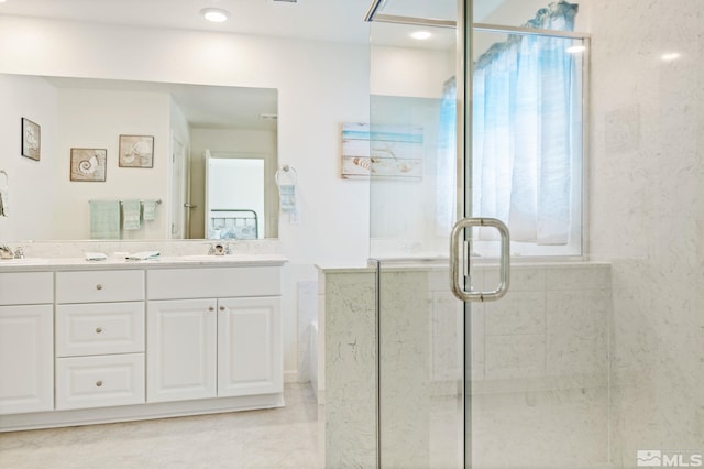 bathroom with vanity and a shower with shower door