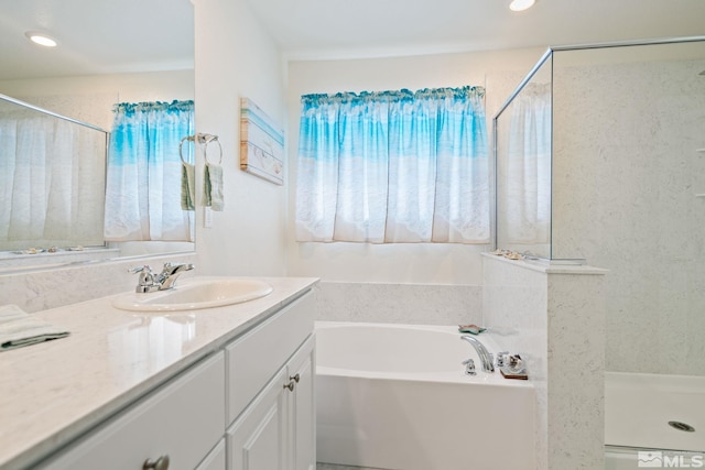 bathroom with vanity and independent shower and bath