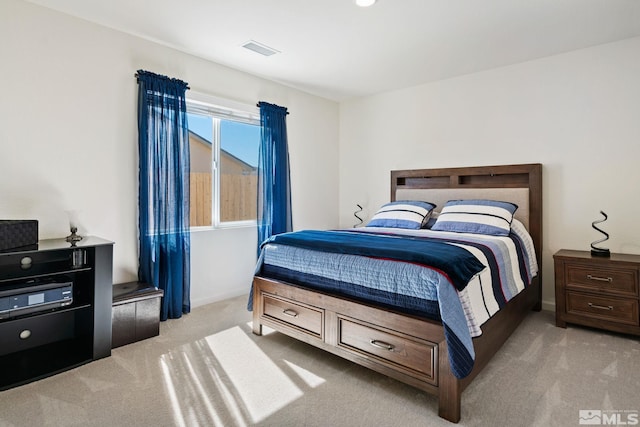 bedroom featuring light carpet