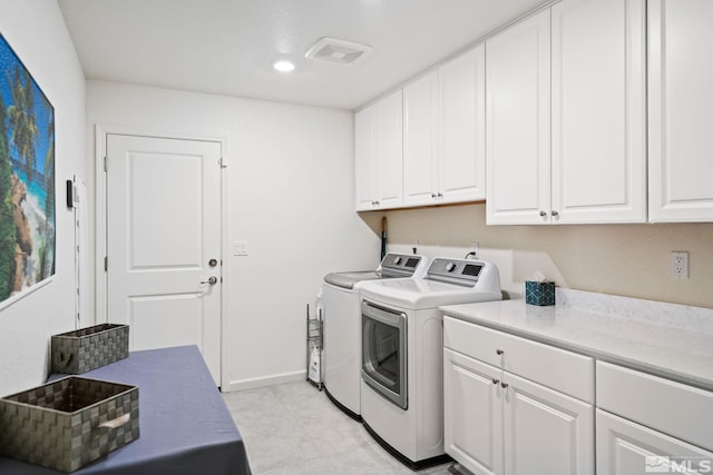 washroom with cabinets and independent washer and dryer