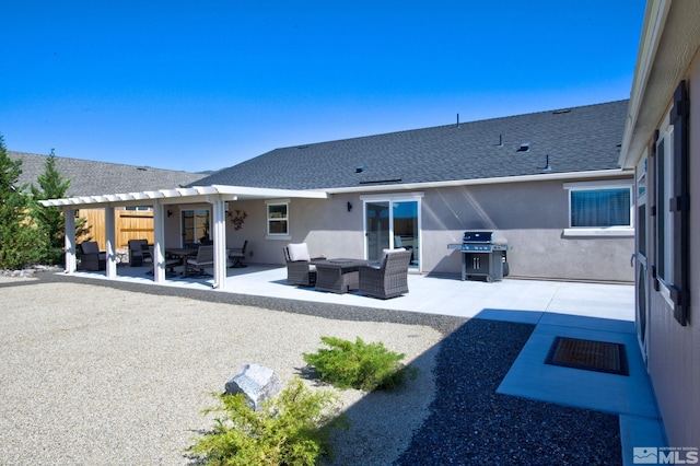 rear view of property featuring outdoor lounge area and a patio