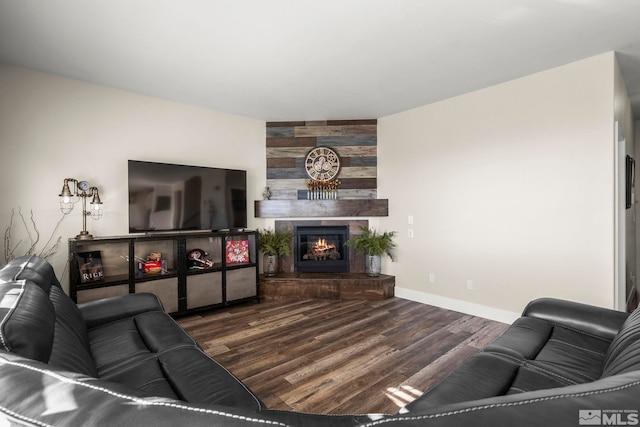 living room with dark hardwood / wood-style floors and a tile fireplace