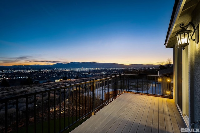 deck at dusk featuring a mountain view