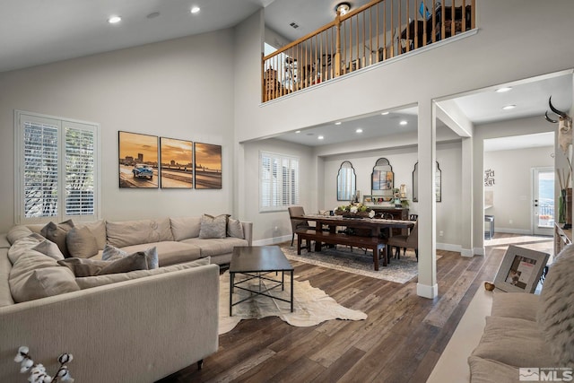 living room with high vaulted ceiling and dark hardwood / wood-style floors