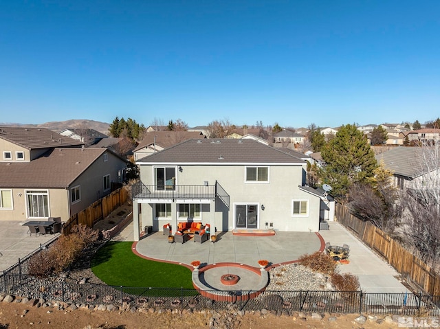 back of property featuring a patio and a balcony