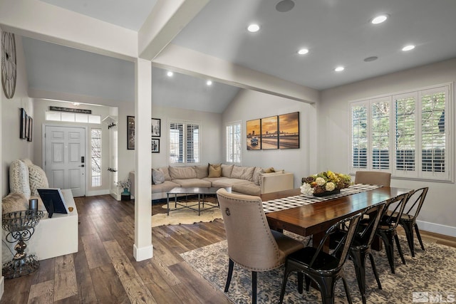 dining room with vaulted ceiling with beams and dark hardwood / wood-style flooring