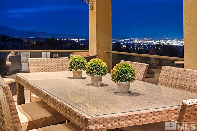 patio at night with a mountain view and a balcony