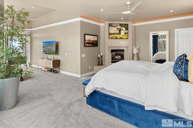 bedroom featuring carpet flooring, ceiling fan, a fireplace, and crown molding