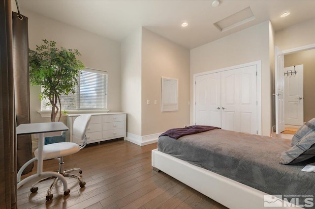 bedroom featuring dark hardwood / wood-style flooring and a closet