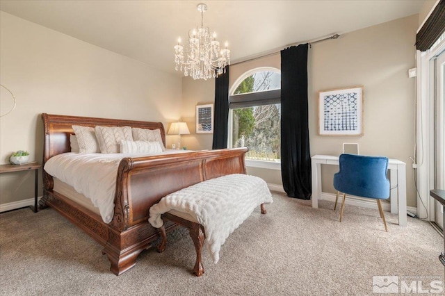 bedroom with light colored carpet and a chandelier