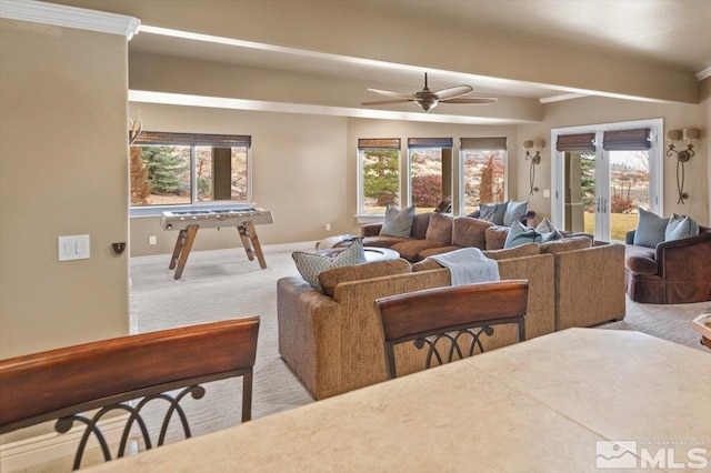 carpeted living room featuring ceiling fan and plenty of natural light