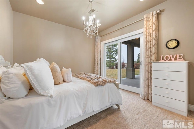 bedroom featuring access to exterior and a notable chandelier