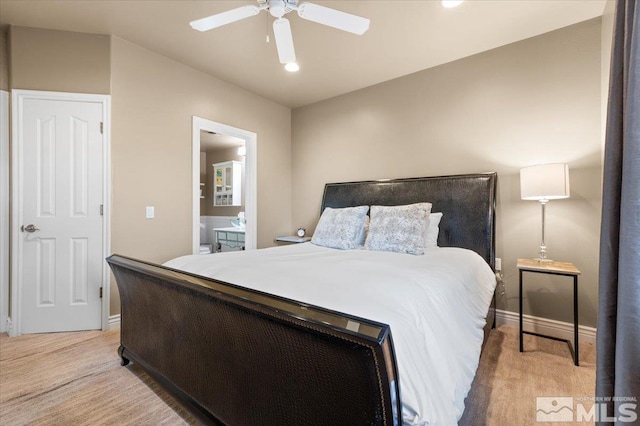 carpeted bedroom featuring ensuite bathroom and ceiling fan