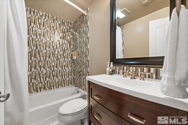 full bathroom featuring vanity, toilet, tasteful backsplash, and shower / tub combo with curtain