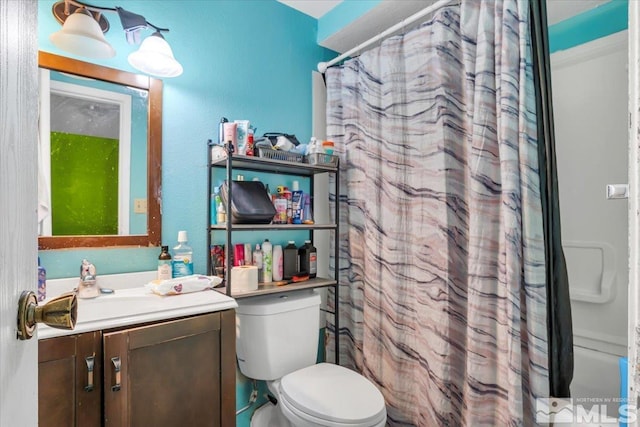 full bathroom featuring shower / bath combo, vanity, and toilet