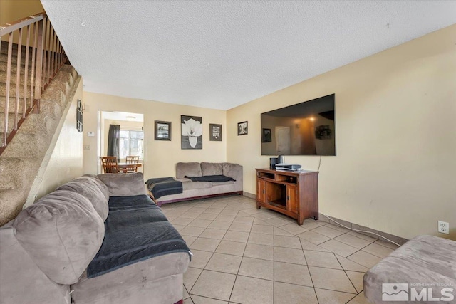 tiled living room featuring a textured ceiling