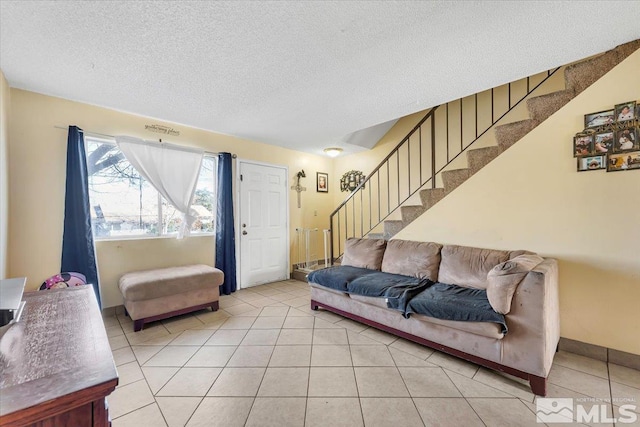 living room with light tile patterned flooring and a textured ceiling