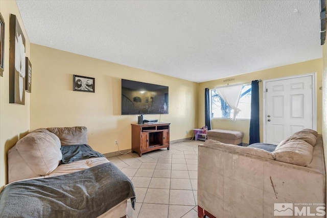 living room featuring light tile patterned flooring and a textured ceiling