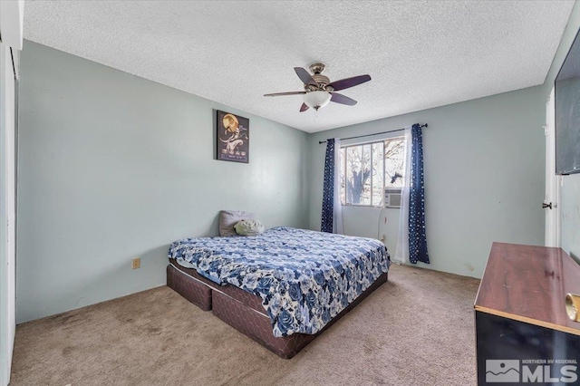 bedroom with ceiling fan, a textured ceiling, and light carpet