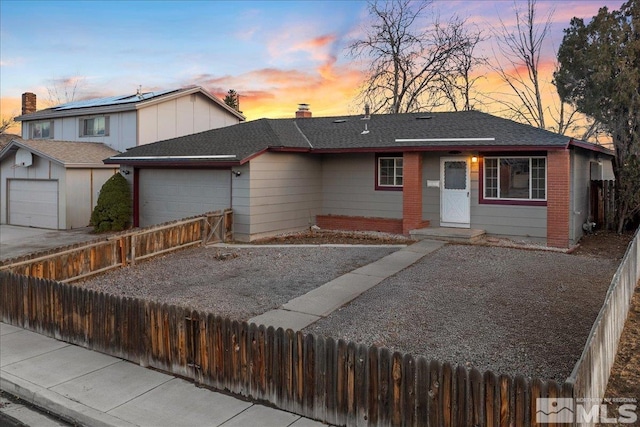 view of front of home with a garage, a shingled roof, concrete driveway, a chimney, and fence private yard