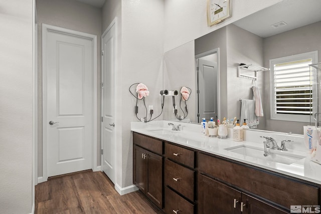 bathroom with hardwood / wood-style floors and vanity