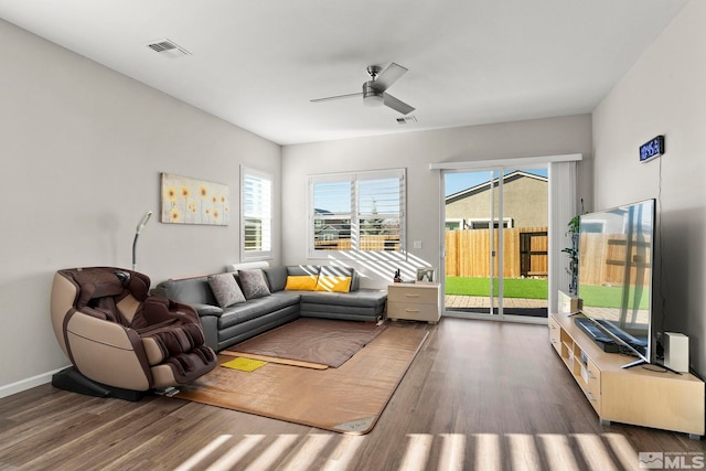 living room featuring ceiling fan and dark wood-type flooring