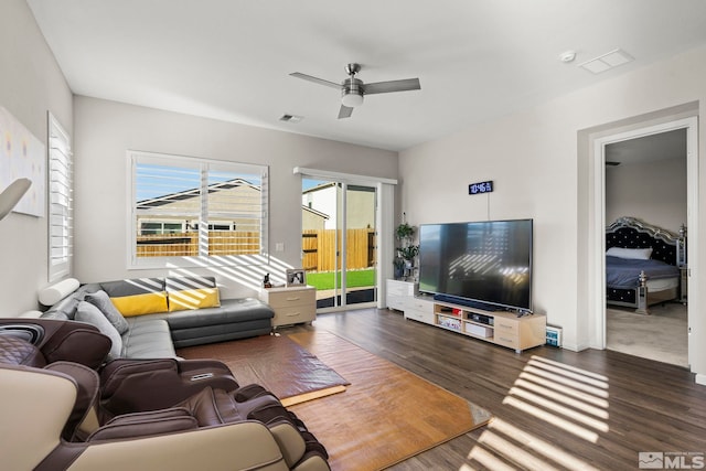 living room featuring dark hardwood / wood-style floors and ceiling fan