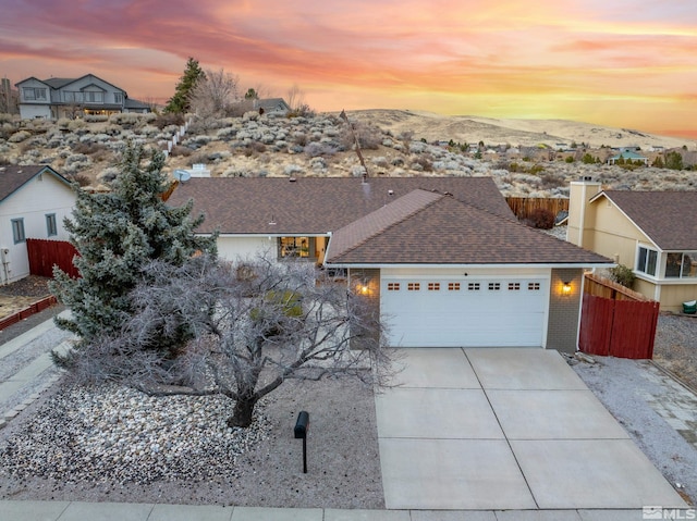 view of front facade featuring a mountain view and a garage